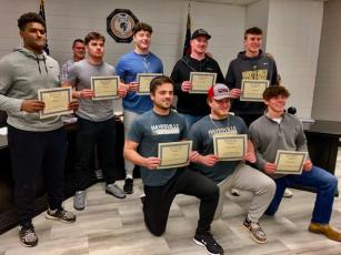 Athletes, front from left, Seth Leek, Dawson DeVane and Michael Mauney, back, Will Brown, Tre Graves, Taylor McClure, Lane O’Dell and Isaac Chandler received recognition at the Clay County Schools Board of Education meeting from Coach McClure for their individual and superior performance in football.