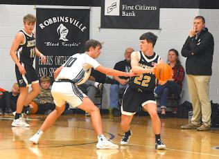 Gary Corsair • Clay County Progress Hayesville’s Jacob McClure, No. 22, looks for a cutter as Isaac Chandler, No. 11, spots up into the corner. 