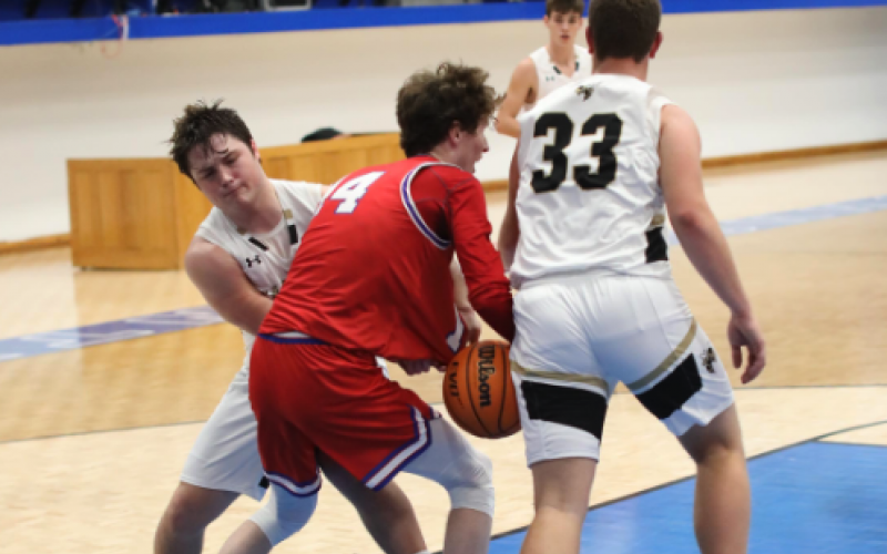 (Photo by Kelli Graves / Clay County Progress) Junior Blake McClure fights for the ball in the first round of the Battle of the States tournament. 