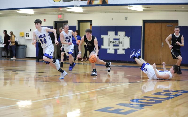 (Kelli Graves * Clay County Progress) Jake McTaggart leaves an Eagle in his wake as he rumbled up the floor.