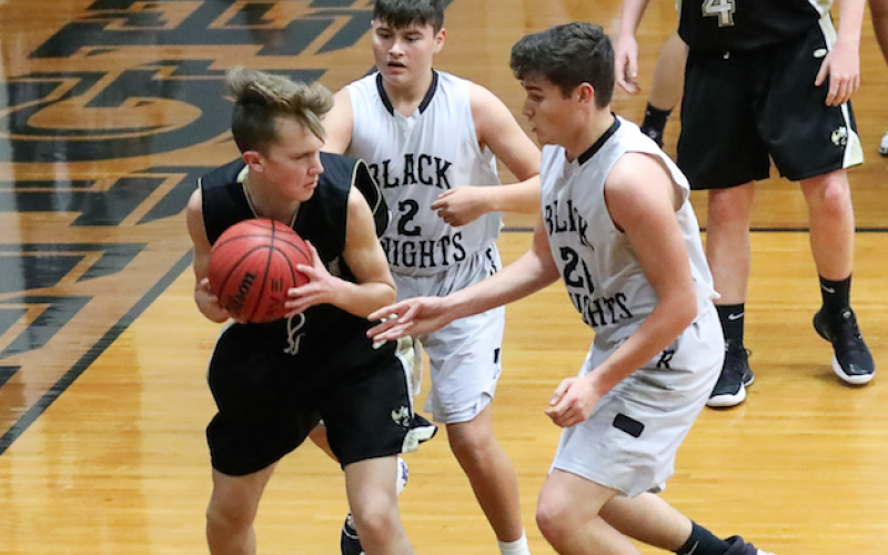 Seth Hedden finds himself in a double team situation against Robbinsville.