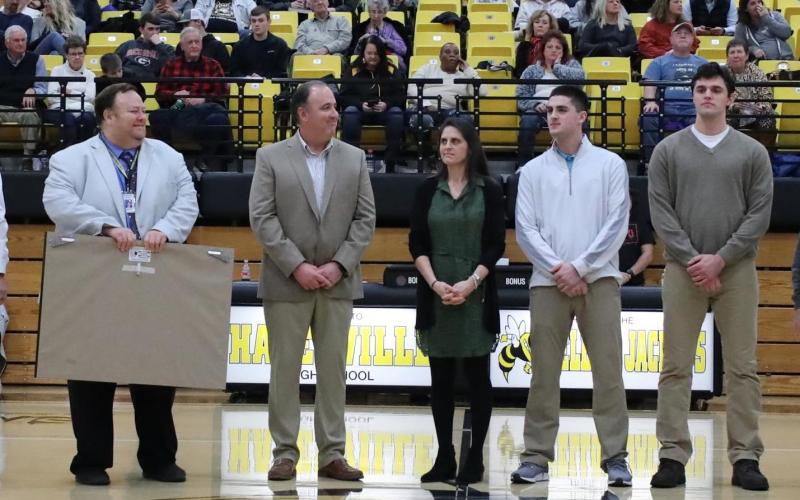 (Kelli Graves • Clay County Progress) Hayesville head coach Mike Cottrell, flanked by HHS principal Jim Saltz to his right and wife Jenny, and sons Josh and Zach to his left, is honored for his 400th win as coach of the Yellow Jackets.