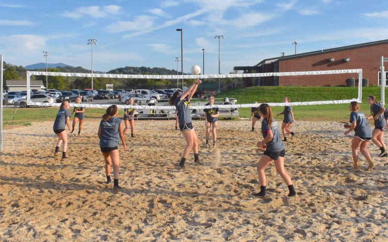 (Travis Dockery • Clay County Progress) The volleyball squads from Hayesville High School swarm the newly-finished outdoor court at the Clay County Recreation Center. 