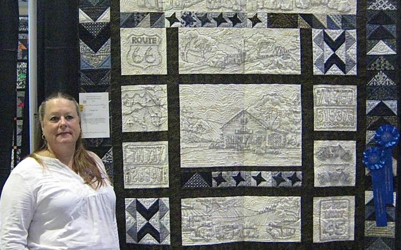Audrey Bower with a blue-ribbon winning quilt.