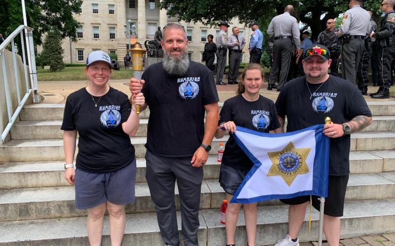 From left, Law Enforcement Torch Run Athlete Ambassadors Robin Calloway, of Mecklenburg County, Sheriff Bobby Deese, Cameron Wilson, of Union County, and Junior Captain Cameron Adams participate in the Special Olympics. Deese was a torch bearer.