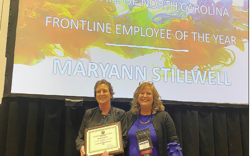 Maryann Stilwell, left, receives the NC Child Support Employee of the Year award from NC DHHS Senior Director for Human Services, Carla West during a recent ceremony in Cherokee, N.C