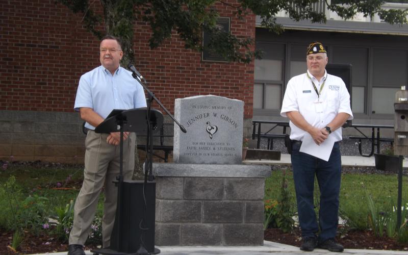 Deby Jo Ferguson • Clay County Progress Andy Gibson, joins American Legion Commander Robert Seibert at the podium during the Friday, Sept. 9 dedication of the memorial site and flag pole dedicated to the memory of Andy’s wife of 21 years and Hayesville High and Middle School’s long-time band director, Jennifer Gibson.