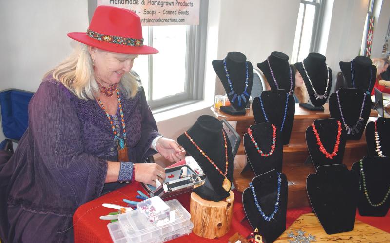 Becky Long •Clay County Progress Robyn Brechbill creates a set of holiday theme earrings during Friday’s Made in the Mountains event for local vendors at the Beal Center. Brechbill reported good attendance from shoppers.