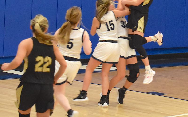 Gary Corsair • Clay County Progress Hayesville's Ava Shook runs into resistance as she attempts to score on a lay-up as teammate Emma Ashe, No. 22, trails the fast break.