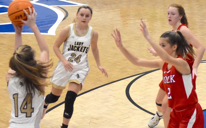 Hayesville's Emma Ashe, No. 24, makes a cut against Polk County while Briley Clampitt, No. 14, looks for an open teammate.