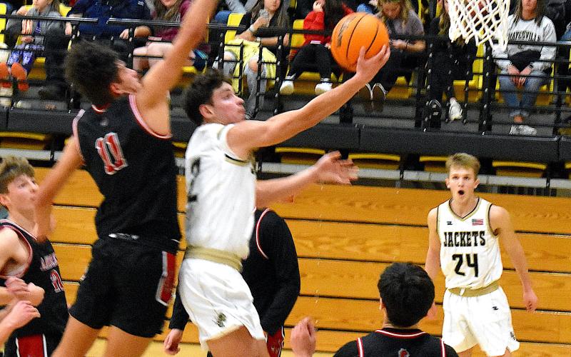 Gary Corsair • Clay County Progress Hayesville's Logan Caldwell, No. 2, glides to the basket for 2 of his 8 points in Hayesville's 66-40 win over Andrews on Saturday.