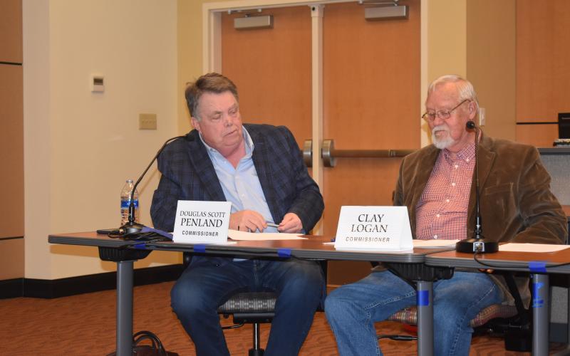 Becky • Clay County Progress Commissioners Scotty Penland, left, and Clay Logan review resolutions calling for several major projects to be built here through grants instead of property taxes.