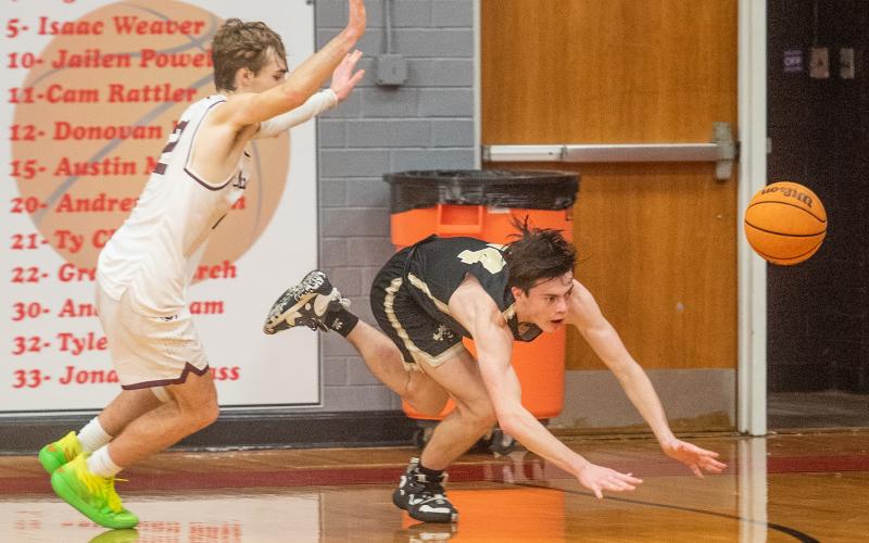 Photo by Byron Housley Hayesville's Slade Crouch, No. 14, dives for a loose ball in the JV Yellow Jackets 44-34 win over Cherokee in the conference tournament at Andrews Thursday.