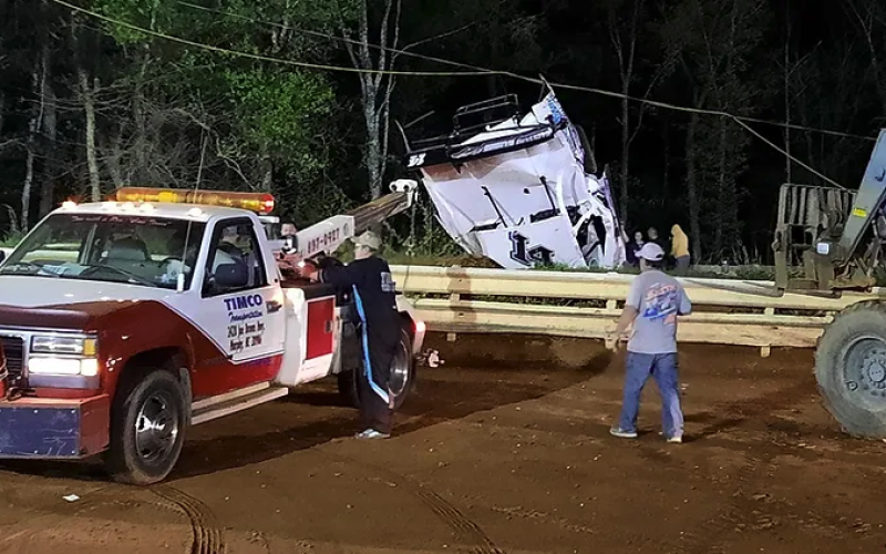Travis Dockery • 389 Country Track officials work on recovering Logan Wall's car after a wild ride.