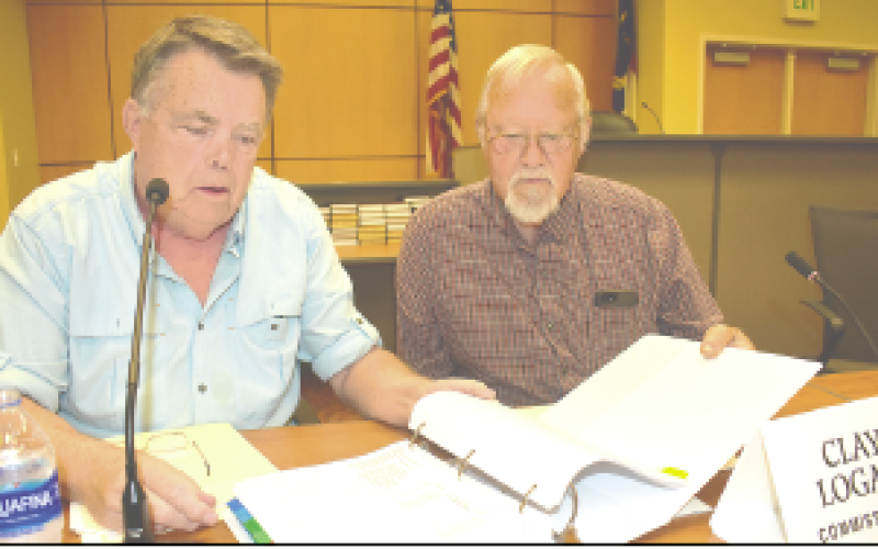 Becky Long • Clay County Progress Commissioners’ Scotty Penland and Clay Logan look over the 2023-24 budget which comprises several hundred pages. Commissioners had been studying the budget for several weeks before approving it on June 15,