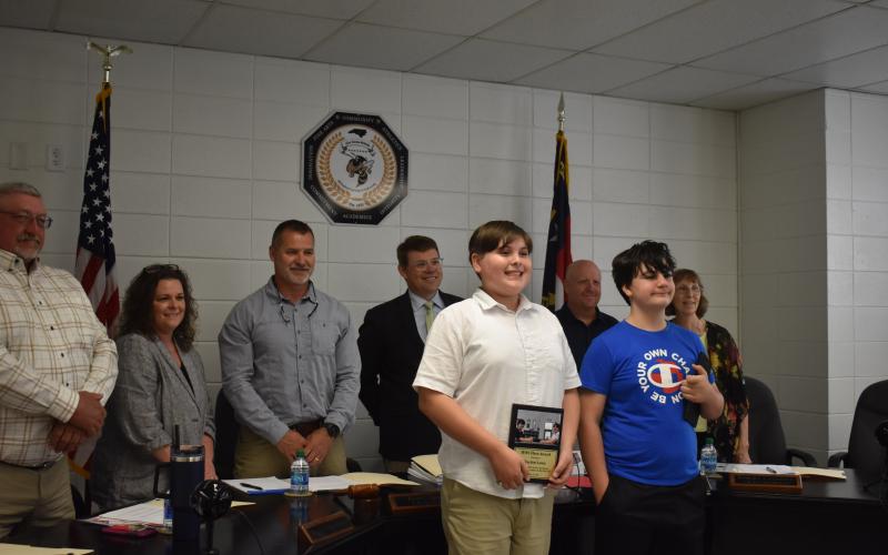 Hayesville Middle School administration recognized Hayden Lewis, left, as Hayesville Middle School hero for using the Heimlich maneuver to save Sean Morris, right.