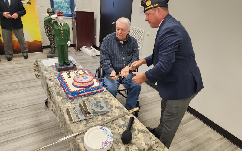 Mark Runge and Randy Fletcher performed the traditional cutting of the cake with a saber.