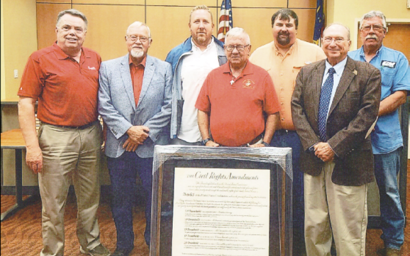 Betty Bradley • Photo Commissioners are presented a framed replica of Civil Rights Amendments during their Aug. 3 meeting. From left, Commissioners’ Scotty Penland, Clay Logan, Rob Peck, Randy Nichols and Dwight Penland. Making the presentation are, in front, Ron Lewis and Dr. David Streater of Foundation Forward.