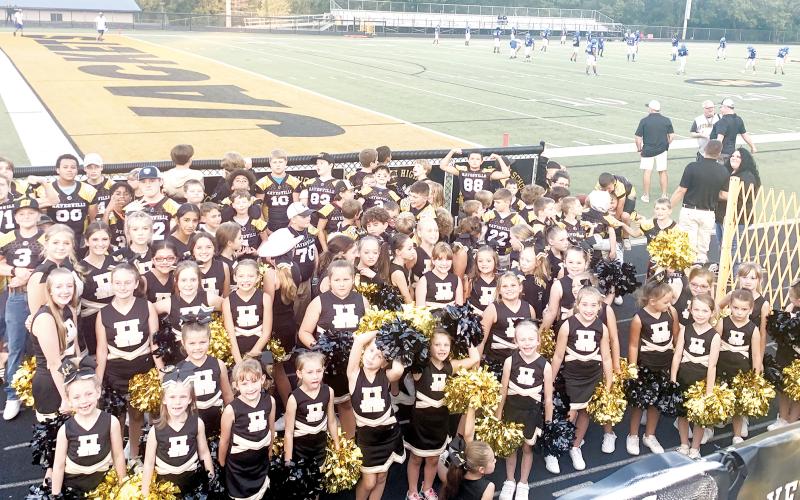Youth cheerleaders and football players