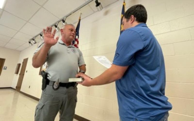 Randy Foster/editor@cherokeescout.com Andrews Interim Police Chief David Southards, left, is administered the oath of office by Town Clerk Ethan McCubbin at the facilities building Friday.
