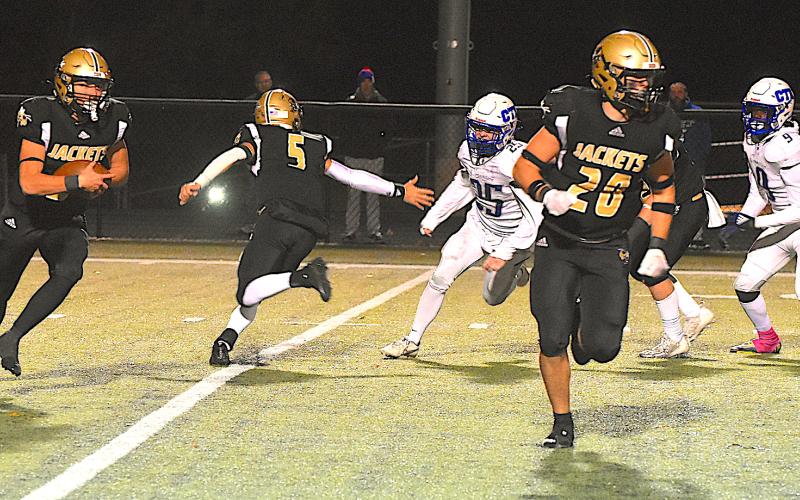 Gary Corsair • Clay County Progress Taylor McClure, No. 20, leads Tre Graves, No. 6, on a Hayesville sweep as quarterback Tate Roberts, No. 5, convincingly fakes left.