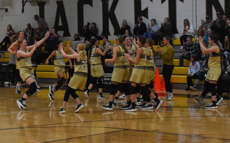 Kelce Oliver • Clay County Progress The Lady Jackets trade high fives in celebration of their win against the Andrews Wildcats.