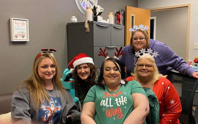 Front from left, Jessica Ellis, Rebeka Snyder, Stephanie Elliott and Shannon Lundquist; back, Tabby Sellers are having fun getting the gifts together for the children.