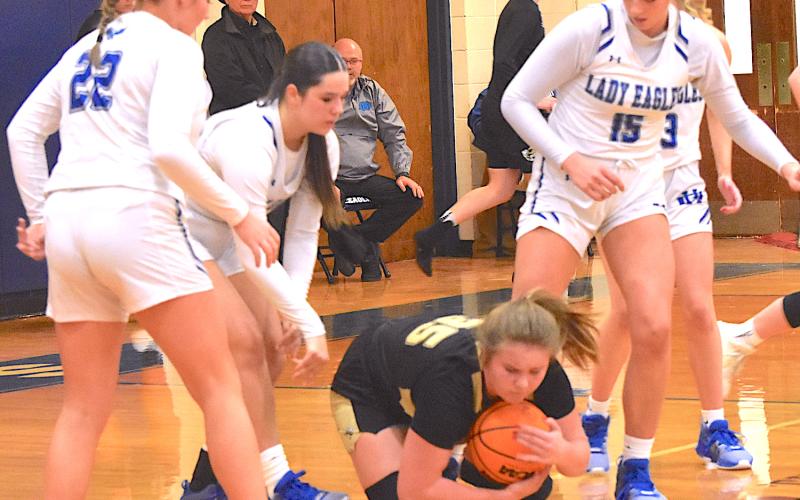 Gary Corsair • Clay County Progress Hayesville’s Mallory Peck smoothers the ball as four out of five Lady Eagles converge on her.