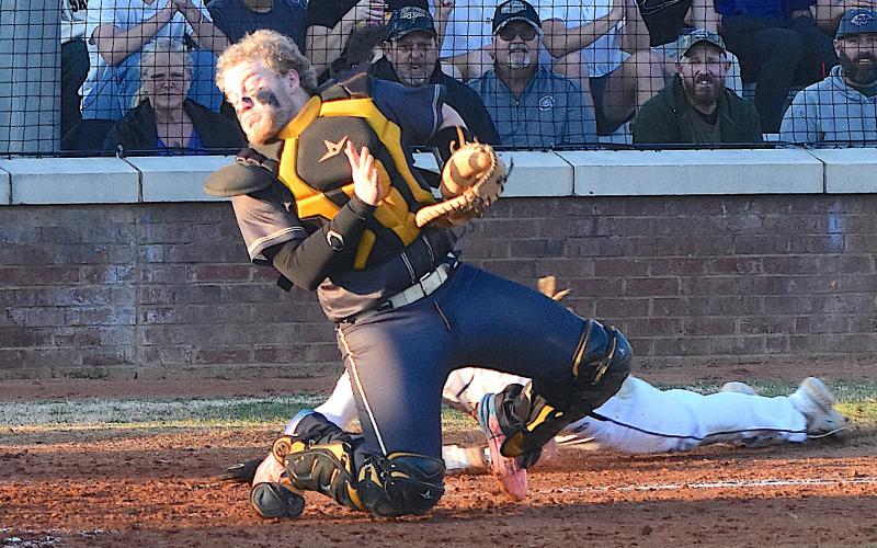 Gary Corsair • Clay County Progress Hayesville catcher Dustin Devane endeavors to keep the baseball in front of him on a low throw on a close play at the plate at Union County.