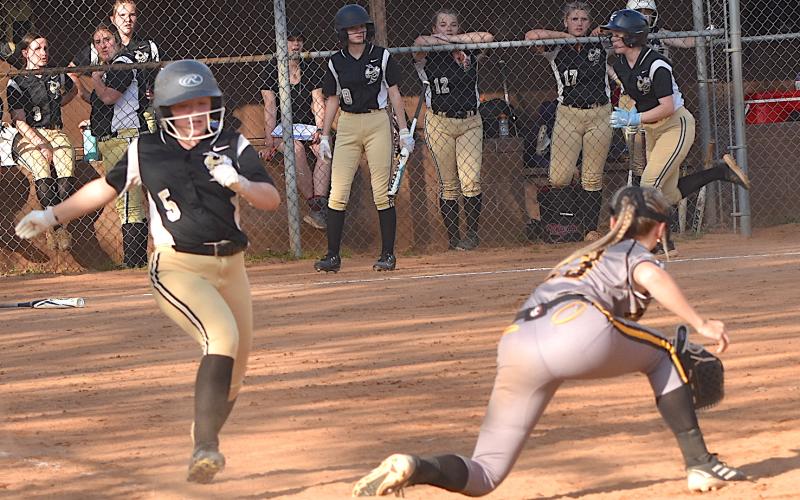 Gary Corsair • Clay County Progress Hayesville's Callie Long, No. 5, legs out a bunt as teammate Raelynn Taylor motors down the third baseline to score the Lady Jackets' fourth run.