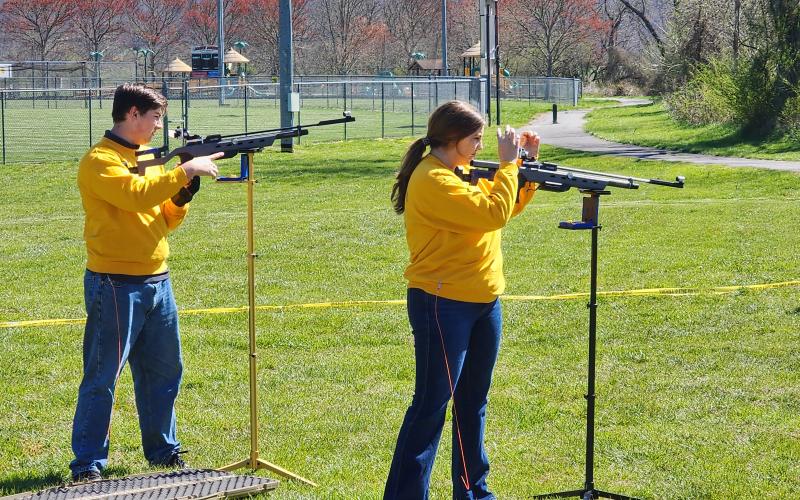 Robert Seibert • Photo Will Jennings and Maggie McClure are demonstrating the air rifles they use in the Junior Shooting Sports Program.